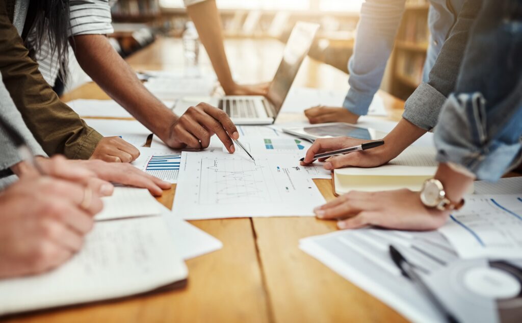 Business,People,,Collaboration,And,Paperwork,With,Hands,,Statistics,And,Social
